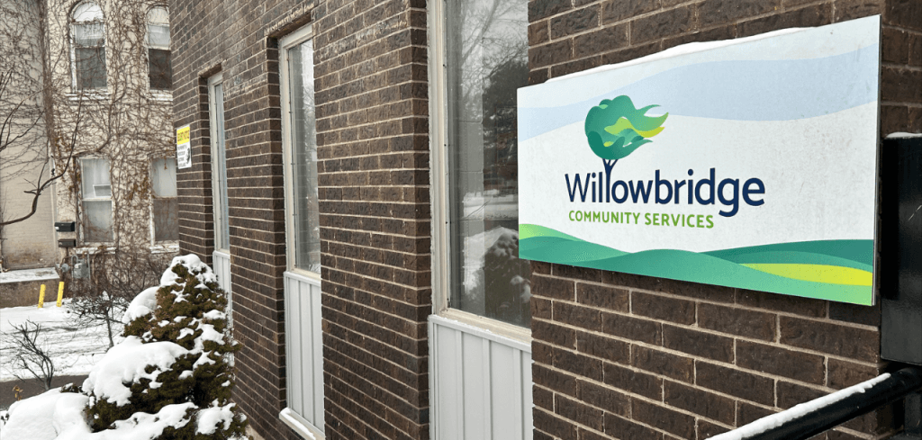 Close up shot of the front of Willowbridge's building with sign with Willowbridge's logo.